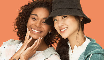 Two women posing for with imPRESS Beauty press-on nails and press-on lashes. Instant beauty from imPRESS no glue needed.