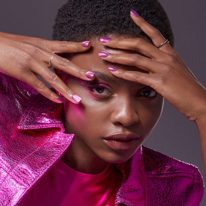A woman modeling her hands by her face. Nails are press-on nails from imPRESS in &