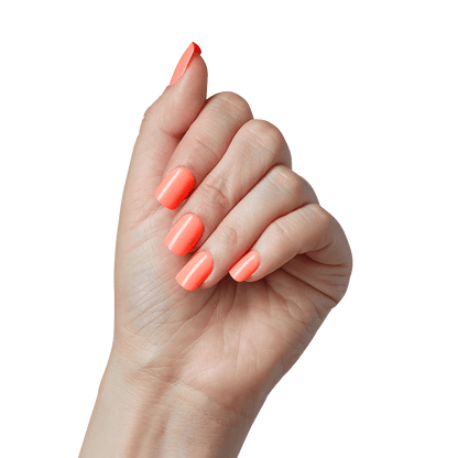 A hand modeling a shiny, short, squoval press on manicure in an orange tone. Nails are from imPRESS in &