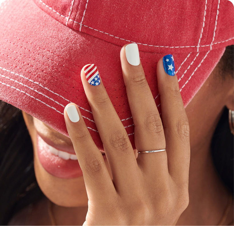 Patriotic nail art with American flag designs on white and blue nails.