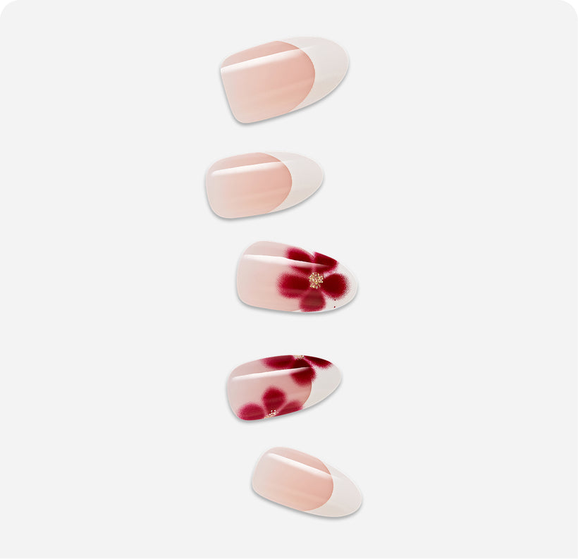 Five oval press-on nails with nude base and burgundy floral designs with rhinestones