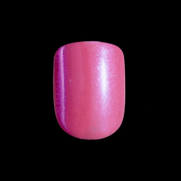 Close-up of a short, squoval shaped nail in shimmery, hot pink. Nail is a press-on nail from imPRESS Color FX collection in &