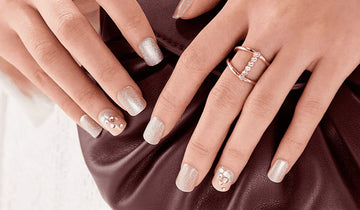 Closeup view of short press on nails by imPRESS Manicure. Nails are pre-polished with glitter nail polish and rhinestones.