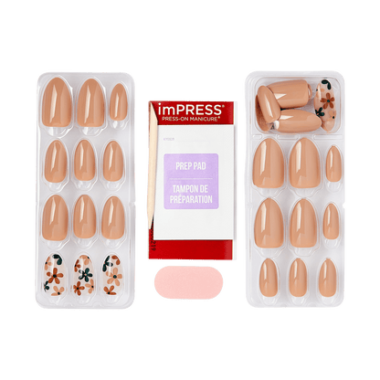 Set of glossy press-on nails in nude and floral designs arranged in two plastic trays, with a red and white prep pad package labeled \