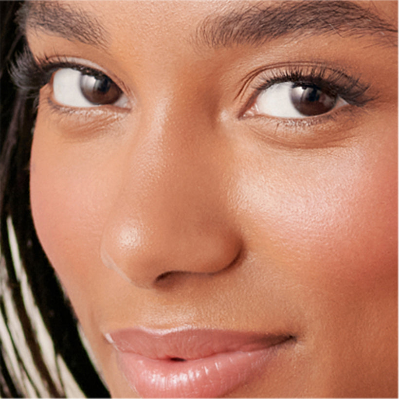 Woman wearing imPRESS Demi-Bold press-on nails, close-up of face and manicure.
